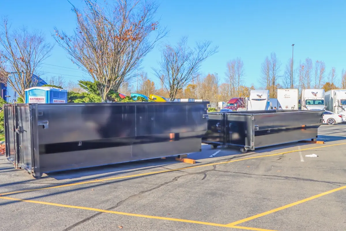 Professional dumpster rental service with roll-off container on residential driveway in Dacula